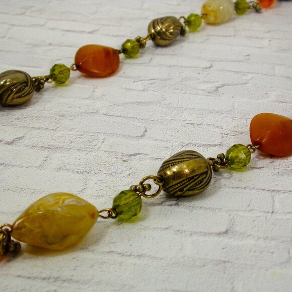 Multi color bead necklace with a mix of beige, green, and deep orange tones. - Picture 2 of 11